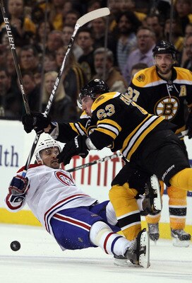 BOSTON, MA - APRIL 14:  Brad Marchand #63 of the Boston Bruins hits Tomas Plekanec #14 of the Montreal Canadiens  in Game One of the Eastern Conference Quarterfinals during the 2011 NHL Stanley Cup Playoffs at TD Garden on April 14, 2011 in Boston, Massac