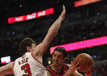 Omer Asik of Chicago guards a New Jersey Net