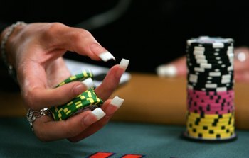 LAS VEGAS - JULY 30:  Poker player Liz Lieu plays with her chips as she competes on the third day of the first round of the World Series of Poker no-limit Texas Hold 'em main event at the Rio Hotel & Casino July 30, 2006 in Las Vegas, Nevada. More than 8,