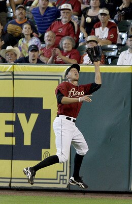 HOUSTON,TX- APRIL 10 : Right fielder Hunter Pence #9  of the Houston Astros catches Wes Helms #18 of the Florida Marlins fly ball on the warning track in the second inning in a MLB  baseball game on April 10, 2011 at Minute Maid Park in Houston, Texas. (P