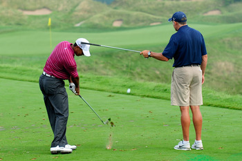 KOHLER, WI - AUGUST 10:  Tiger Woods works on his golf swing with his caddie Steve Williams (R) during a practice round prior to the start of the 92nd PGA Championship on the Straits Course at Whistling Straits on August 10, 2010 in Kohler, Wisconsin.  (P