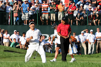 CHASKA, MN - AUGUST 16:  (L-R) Y.E. Yang of South Korea celebrates a birdie putt on the 18th green alongside Tiger Woods during the final round of the 91st PGA Championship at Hazeltine National Golf Club on August 16, 2009 in Chaska, Minnesota.  (Photo b