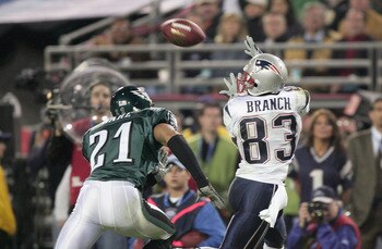 JACKSONVILLE, FL - FEBRUARY 6:  Wide receiver Deion Branch #83 of the New England Patriots receives a pass over Matt Ware #21 of the Philadelphia Eagles during Super Bowl XXXIX at Alltel Stadium on February 6, 2005 in Jacksonville, Florida. The Patriots d