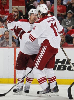 DETROIT, MI - APRIL 16:  Shane Doan #19 of the Phoenix Coyotes celebrates a third-period goal with teammates Martin Hanzal #11 while playing the Detroit Red Wings in Game Two of the Western Conference Quarterfinals during the 2011 Stanley Cup Playoffs at