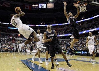WASHINGTON, DC - MARCH 05:  Jordan Crawford #15 of the Washington Wizards puts up a shot in front of Wayne Ellington #19 and Michael Beasley #8 of the Minnesota Timberwolves at the Verizon Center on March 5, 2011 in Washington, DC. NOTE TO USER: User expr