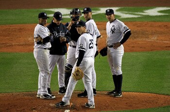 NEW YORK - OCTOBER 18:  Manager Joe Girardi, Jorge Posada #20, Mark Teixeira #25, Robinson Cano #24, Alex Rodriguez #13 and Derek Jeter #2 of the New York Yankees look on during a pitching change against the Texas Rangers in Game Three of the ALCS during