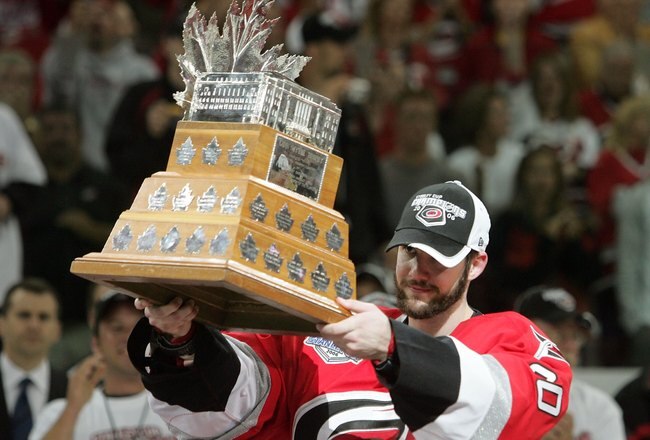RALEIGH, NC - JUNE 19:  Goaltender Cam Ward #30 of the Carolina Hurricanes raises the Conn Smythe trophy after defeating the Edmonton Oilers in game seven of the 2006 NHL Stanley Cup Finals on June 19, 2006 at the RBC Center in Raleigh, North Carolina. Th