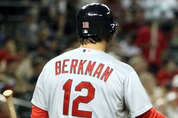 PHOENIX, AZ - APRIL 12:  Ryan Theriot #3 of the St. Louis Cardinals high fives teammate Lance Berkman #12 after scoring a fifth inning run against the Arizona Diamondbacks during the Major League Baseball game at Chase Field on April 12, 2011 in Phoenix,