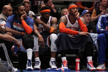 NEW YORK, NY - APRIL 22:  (L-R) Ronny Turiaf #14, Bill Walker #5 and Carmelo Anthony #7 of the New York Knicks look on dejected from the bench against the Boston Celtics in Game Three of the Eastern Conference Quarterfinals in the 2011 NBA Playoffs on Apr