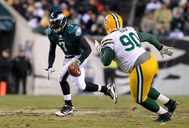 PHILADELPHIA, PA - JANUARY 09:  Michael Vick #7 of the Philadelphia Eagles scrtambles against B.J. Raji #90 of the Green Bay Packers during the 2011 NFC wild card playoff game at Lincoln Financial Field on January 9, 2011 in Philadelphia, Pennsylvania.  (