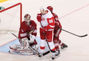 GLENDALE, AZ - APRIL 20:  Goaltender Ilya Bryzgalov #30 of the Phoenix Coyotes makes a save on the shot as Tomas Holmstrom #96 of the Detroit Red Wings looks for a rebound in Game Four of the Western Conference Quarterfinals during the 2011 NHL Stanley Cu