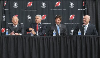 NEWARK, NJ - JULY 20:  (L-R) General Manager Lou Lamoriello, owner Jeff Vanderbeek, Ilya Kovalchuk, and head coach John Maclean of the New Jersey Devils speak with the media during a press conference announcing his contract renewal at the Prudential Cente