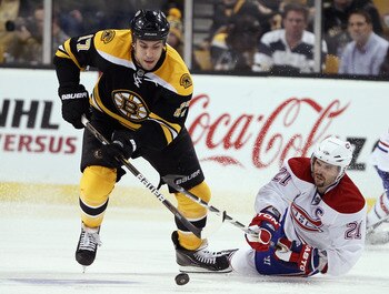 BOSTON, MA - APRIL 14:  Milan Lucic #17 of the Boston Bruins steals the puck from Brian Gionta #21 of the Montreal Canadiens in Game One of the Eastern Conference Quarterfinals during the 2011 NHL Stanley Cup Playoffs at TD Garden on April 14, 2011 in Bos