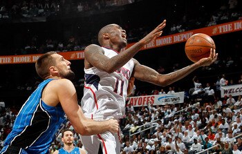 ATLANTA, GA - APRIL 22:  Jamal Crawford #11 of the Atlanta Hawks draws a foul from Ryan Anderson #33 of the Orlando Magic during Game Three of the Eastern Conference Quarterfinals in the 2011 NBA Playoffs at Philips Arena on April 22, 2011 in Atlanta, Geo