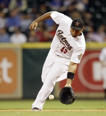 HOUSTON - APRIL 12:  First baseman Carlos Lee #45 of the Houston Astros fields a ground ball against the Chicago Cubs at Minute Maid Park on April 12, 2011 in Houston, Texas.  (Photo by Bob Levey/Getty Images)