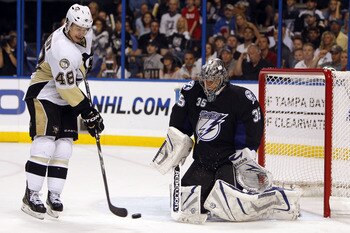 TAMPA, FL - APRIL 20: Goaltender Dwayne Roloson #35 of the Tampa Bay Lightning defends the net against Tyler Kennedy #48 of the Pittsburgh Penguins in Game Four of the Eastern Conference Quarterfinals during the 2011 NHL Stanley Cup Playoffs at the St. Pe