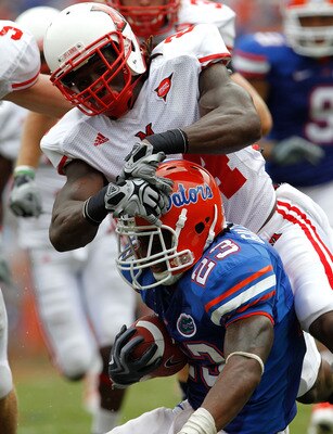 GAINESVILLE, FL - SEPTEMBER 04:  Mike Gillislee #23 of the Florida Gators is tackled by Allen Veazie #2 of the Miami University RedHawks at Ben Hill Griffin Stadium on September 4, 2010 in Gainesville, Florida.  (Photo by Sam Greenwood/Getty Images)