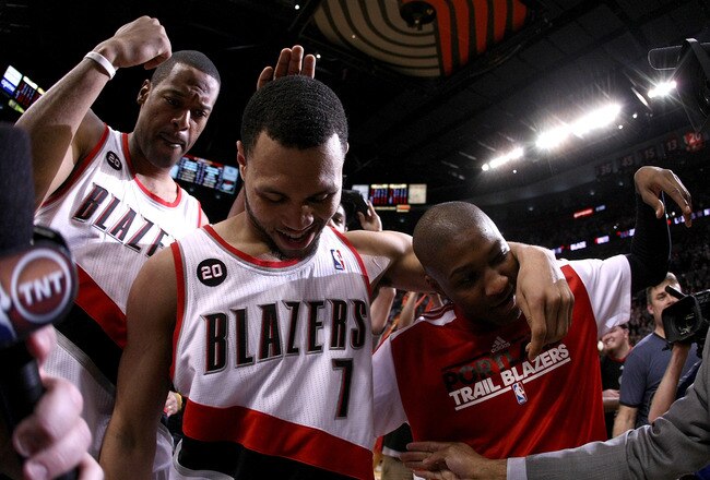 PORTLAND, OR - APRIL 23:  Brandon Roy #7 of the Portland Trail Blazers celebrates with teammates Marcus Camby #23 and Armon Johnson #1 after overcoming a 23 point deficit to defeat the of the Dallas Mavericks 84-82 in Game Four of the Western Conference Q
