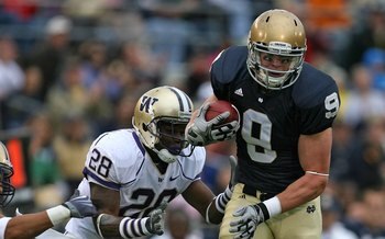 SOUTH BEND, IN - OCTOBER 03: Kyle Rudolph #9 of the Notre Dame Fighting Irish breaks away from Quinton Rochardson #28 of the Washington Huskies after catching the ball on October 3, 2009 at Notre Dame Stadium in South Bend, Indiana. Notre Dame defeated Wa