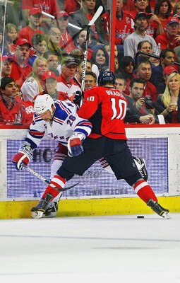 WASHINGTON , DC - APRIL 23:  Matt Bradley #10 of the Washington Capitals battles for the puck as he checks Bryan McCabe #28 of the New York Rangers in Game Five of the Eastern Conference Quarterfinals during the 2011 NHL Stanley Cup Playoffs at the Verizo