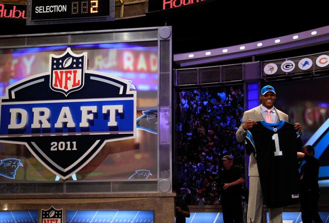NEW YORK, NY - APRIL 28:  Cam Newton, #1 overall pick by the Carolina Panthers holds up a jersey on stage after he was picked during the 2011 NFL Draft at Radio City Music Hall on April 28, 2011 in New York City.  (Photo by Chris Trotman/Getty Images)