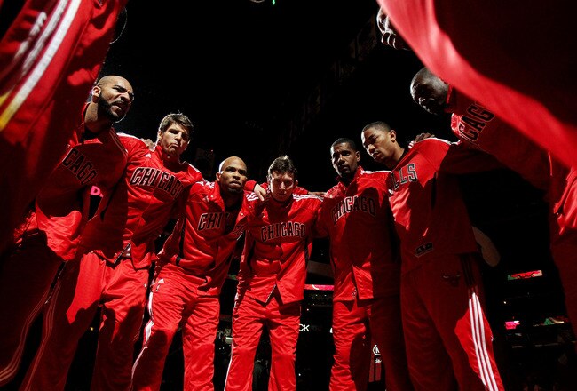 CHICAGO, IL - MARCH 25: Members of the Chicago Bulls including (L-R) Carlos Boozer #5, Kyle Korver #26, Taj Gibson #22, Omer Asik #3, Kurt Thomas #40, Derrick Rose #1, Loul Deng #9 and Keith Bogans #6 huddle before a game against the Memphis Grizzlies at
