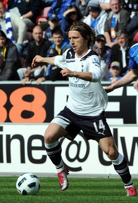 WIGAN, ENGLAND - APRIL 02:  Luka Modric of Tottenham(L) Hotspur is chased by Ben Watson of Wigan Athletic during the Barclays Premier League match between Wigan Athletic and Tottenham Hotspur at DW Stadium on April 2, 2011 in Wigan, England.  (Photo by Ch