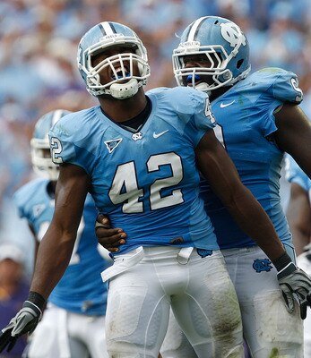 CHAPEL HILL, NC - SEPTEMBER 19:  Robert Quinn #42 of the North Carolina Tar Heels celebrates after a sack with teammate Marvin Austin #9 against the East Carolina Pirates at Kenan Stadium on September 19, 2009 in Chapel Hill, North Carolina.  (Photo by St