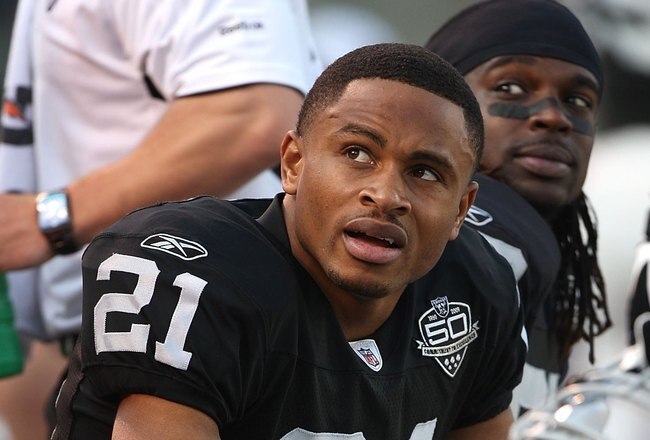 OAKLAND, CA - JANUARY 03:  Nnamdi Asomugha #21 of the Oakland Raiders sits on the bench against the Baltimore Ravens during an NFL game at Oakland-Alameda County Coliseum on January 3, 2010 in Oakland, California.  (Photo by Jed Jacobsohn/Getty Images)