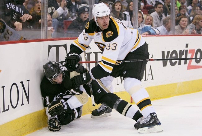PITTSBURGH - DECEMBER 30: Defenseman Zdeno Chara #33 of the Boston Bruins checks forward Evgeni Malkin #71 of the Pittsburgh Penguins on December 30, 2008 at Mellon Arena in Pittsburgh, Pennsylvania.  (Photo by Jamie Sabau/Getty Images)