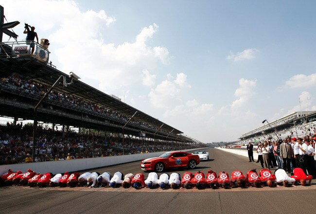 INDIANAPOLIS - MAY 30:  Dario Franchitti of Scotland, driver of the #10 Target Chip Ganassi Racing Dallara Honda, clebrates with his team by kissing the bricks after winning the IZOD IndyCar Series 94th running of the Indianapolis 500 at the Indianapolis