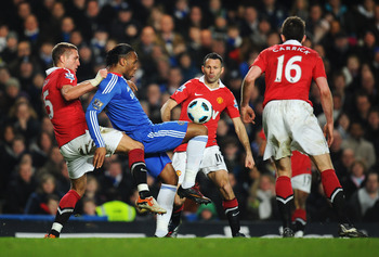 LONDON, ENGLAND - MARCH 01:  Didier Drogba of Chelsea holds the ball up watched by Nemanja Vidic (L), Ryan Giggs and Michael Carrick during the Barclays Premier League match between Chelsea and Manchester United at Stamford Bridge on March 1, 2011 in Lond