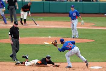 SCOTTSDALE, AZ - MARCH 01:  Gary Brown #86 of the San Francisco Giants safely steals second base under the tag from infielder Bobby Scales #19 of the Chicago Cubs during the spring training game at Scottsdale Stadium on March 1, 2011 in Scottsdale, Arizon