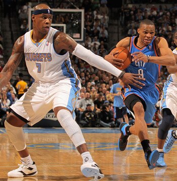 DENVER, CO - APRIL 23:  Russell Westbrook #0 of the Oklahoma City Thunder drives to the basket between Al Harrington #7 and Raymond Felton #20 of the Denver Nuggets in Game Three of the Western Conference Quarterfinals in the 2011 NBA Playoffs on April 23