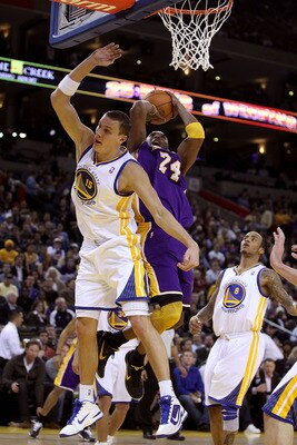 OAKLAND, CA - JANUARY 12: Kobe Bryant #24 of the Los Angeles Lakers is fouled by Andris Biedrins #15 of the Golden State Warriors at Oracle Arena on January 12, 2011 in Oakland, California. NOTE TO USER: User expressly acknowledges and agrees that, by dow