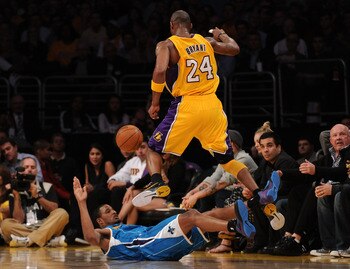 LOS ANGELES, CA - APRIL 26:  Trevor Ariza #1 of the New Orleans Hornets is called for a blocking foul as he is knocked down by Kobe Bryant #24 of the Los Angeles Lakers in the third quarter in Game Five of the Western Conference Quarterfinals in the 2011