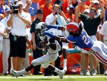 GAINESVILLE, FL - SEPTEMBER 11:   Josh Evans #24 of the Florida Gators attempts to tackle Lindsey Lamar #5 of the South Florida Bulls during a game at Ben Hill Griffin Stadium on September 11, 2010 in Gainesville, Florida.  (Photo by Sam Greenwood/Getty I