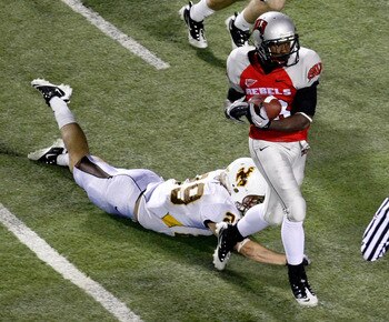 LAS VEGAS - NOVEMBER 13:  Marcus Sullivan #18 of the UNLV Rebels catches a 41-yard touchdown pass in front of Luke Ruff #29 of the Wyoming Cowboys during their game at Sam Boyd Stadium November 13, 2010 in Las Vegas, Nevada. UNLV won 42-16.  (Photo by Eth
