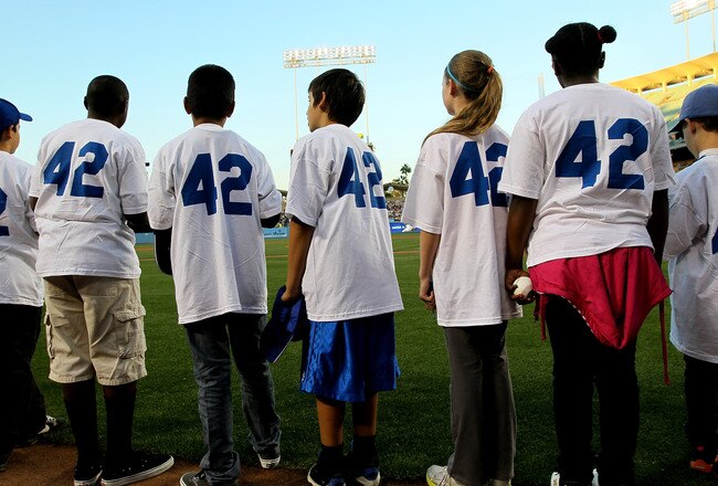 LOS ANGELES, CA - APRIL 15:  Children waiting to take part in pre game activities wear #42  before the game between the Los Angeles Dodgers and the St. Louis Cardinals as Major League Baseball celebrates Jackie Robinson Day on April 15, 2011 at Dodger Sta