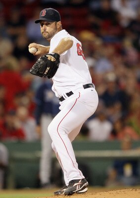 BOSTON - SEPTEMBER 08:  Tim Wakefield #49 of the Boston Red Sox sends the ball to first base in an attempt to catch Ben Zobrist of the Tampa Bay Rays leading off on September 8, 2010 at Fenway Park in Boston, Massachusetts.  (Photo by Elsa/Getty Images)