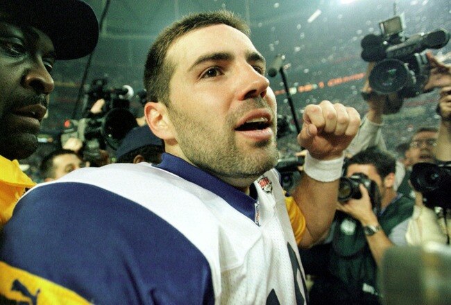 F363722 55: (NORTH AND SOUTH AMERICA SALES ONLY) Quarterback Kurt Warner of the St Louis Rams is escorted off the field after winning Super Bowl XXXIV at the Georgia Dome in Atlanta, Georgia on January 30, 2000. The St. Louis Rams defeated the Tennessee T