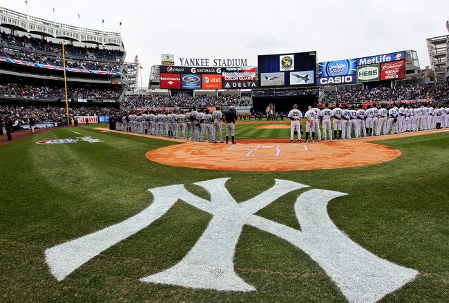 NEW YORK, NY - MARCH 31:  The New York Yankees and the Detroit Tigers look on as West Point Cadets unfurl the American Flag during the opening ceremonies on Opening Day at Yankee Stadium on March 31, 2011 in Bronx borough of New York City.  (Photo by Nick