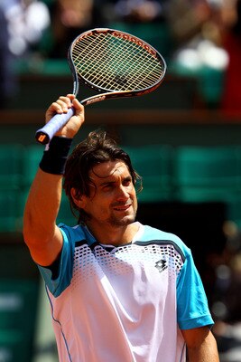 PARIS, FRANCE - MAY 22:  David Ferrer of Spain celebrates match point during the men's singles round one match  between David Ferrer of Spain and Jarkko Nieminen of Finland on day one of the French Open at Roland Garros on May 22, 2011 in Paris, France.