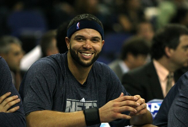 LONDON, ENGLAND - MARCH 04:  #8 Deron Williams of the Netslooks on from the bench during the NBA match between New Jersey Nets and the Toronto Raptors at the O2 Arena on March 4, 2011 in London, England. NOTE TO USER: User expressly acknowledges and agree