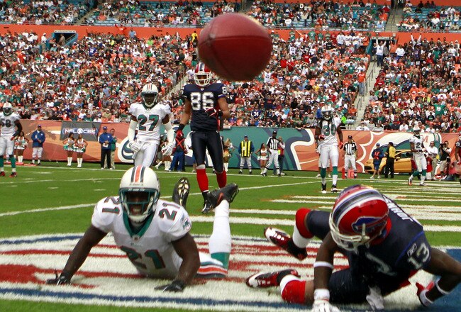 MIAMI - DECEMBER 19:  Defensive back Vontae Davis #21 of the Miami Dolphins breaks up a catch against receiver Steve Johnson #13 of the Buffalo Bills at Sun Life Stadium on December 19, 2010 in Miami, Florida. The Bills defeated the Dolphins 17-14.  (Phot