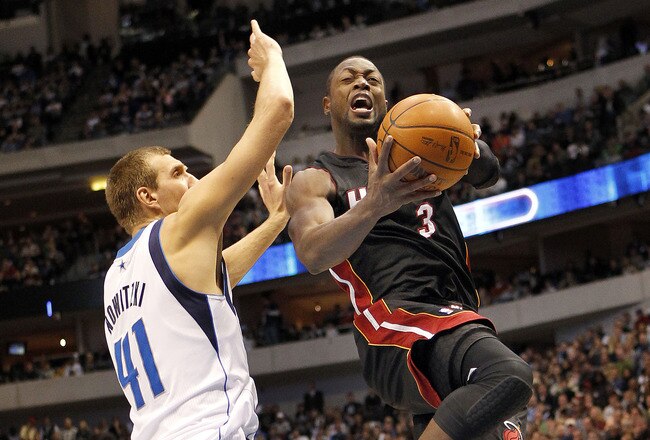 DALLAS - NOVEMBER 27: Dwyane Wade #3 of the Miami Heat drives by Dirk Nowitzki #41 of the Dallas Mavericks on November 27, 2010 at the American Airlines Center in Dallas, Texas. NOTE TO USER: User expressly acknowledges and agrees that, by downloading and
