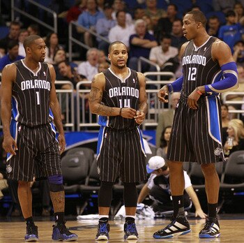 ORLANDO, FL - FEBRUARY 03: (L-R) Guard Gilbert Arenas #1, Guard Jameer Nelson #14, Center Dwight Howard #12 and Forward Earl Clark #3 of the Orlando Magic line against the Miami Heat at Amway Arena on February 3, 2011 in Orlando, Florida. NOTE TO USER: Us