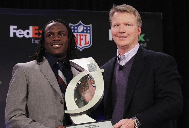 DALLAS, TX - FEBRUARY 02:  Jamaal Charles of the Kansas City Chiefs (L), winner of the FedEx Ground NFL Player of the Year, poses with New York Giants legend Phil Simms at the Super Bowl XLV media center on February 2, 2011 in Dallas, Texas.  (Photo by Ro