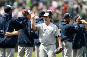 OAKLAND, CA - MAY 30:  Bartolo Colon #40 of the New York Yankees is congratulated by teammates after he pitched a complete game shut out against the Oakland Athletics at Oakland-Alameda County Coliseum on May 30, 2011 in Oakland, California.  (Photo by Ez