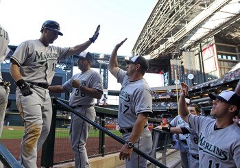 PHOENIX, AZ - MAY 30:  Gaby Sanchez #15 of the Florida Marlins high fives coach Brandon Hyde #17 after hitting a two run home run against the Arizona Diamondbacks during the fifth inning of the Major League Baseball game at Chase Field on May 30, 2011 in